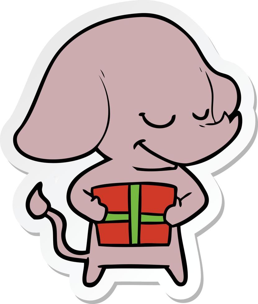 sticker van een cartoon lachende olifant met cadeau vector