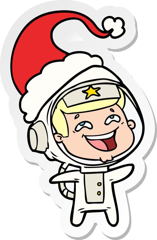 sticker cartoon van een lachende astronaut met een kerstmuts vector