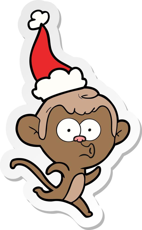 sticker cartoon van een verraste aap met een kerstmuts vector