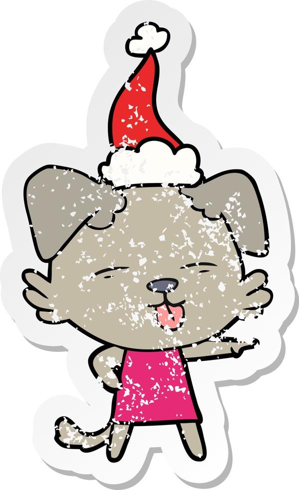 verontruste sticker cartoon van een hond die zijn tong uitsteekt en een kerstmuts draagt vector