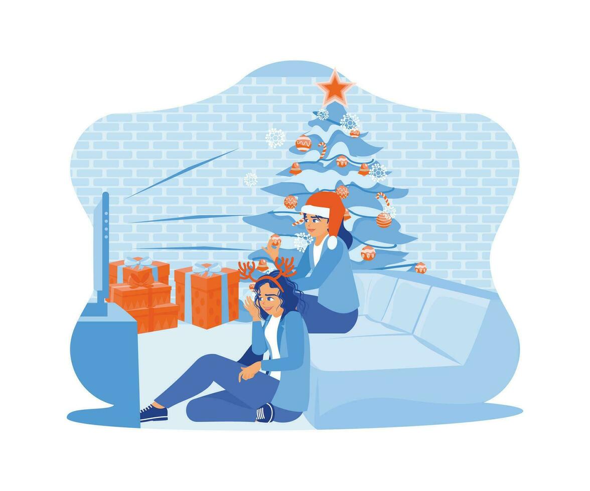 twee vrouw vrienden zittend samen in de buurt de Kerstmis boom. besteden Kerstmis vooravond hebben pret en aan het kijken televisie samen. familie sharing Kerstmis vooravond concept. vector