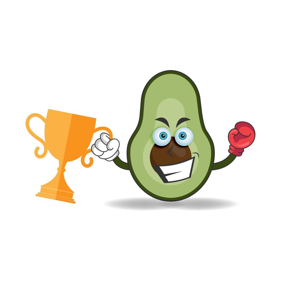 het karakter van de avocado-mascotte wint een bokstrofee. vector illustratie