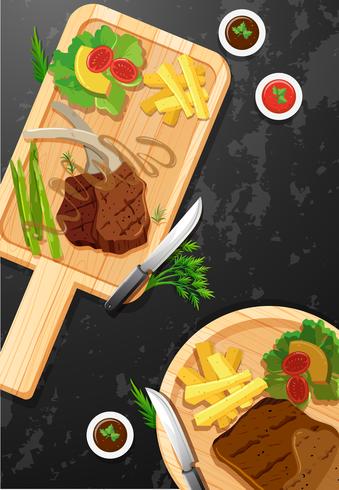 Biefstuk en friet op een houten bord vector