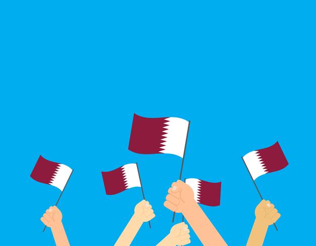 Vectorillustratiehands die de vlaggen van Qatar op blauwe achtergrond houden vector