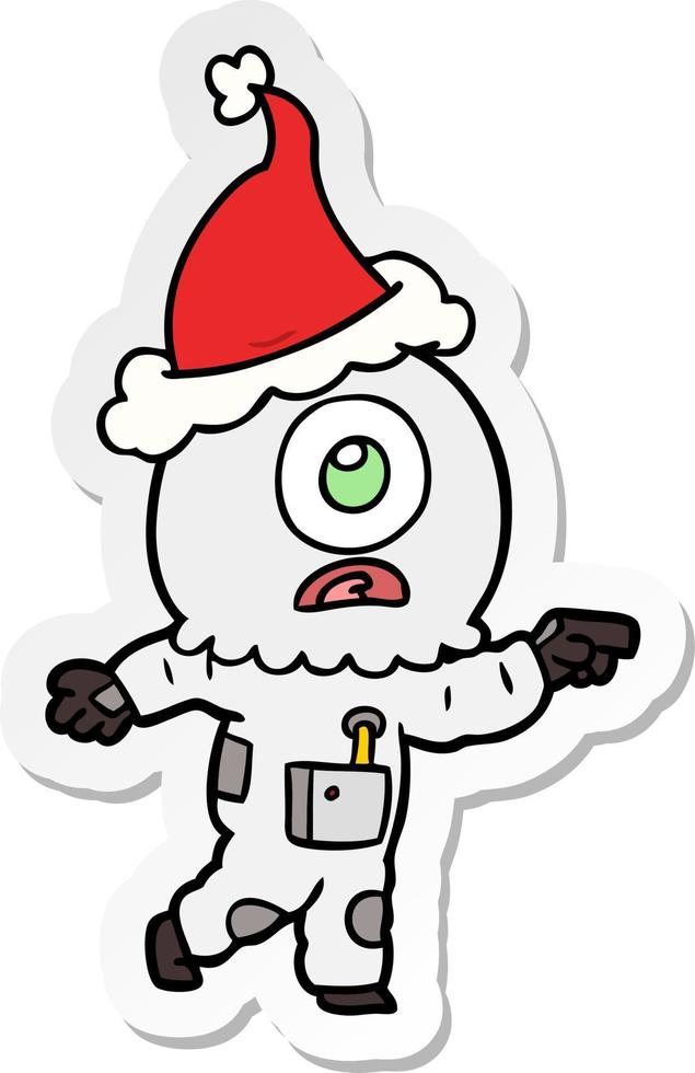 sticker cartoon van een cyclops buitenaardse ruimtevaarder die wijst met een kerstmuts vector