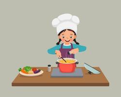 schattige kleine meisjeschef-kok die heerlijke groentesoep kookt met pan die kruiden in de keuken toevoegt vector