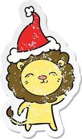 verontruste sticker cartoon van een leeuw met een kerstmuts vector