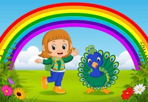 schattig meisje en pauw in het park met regenboogscène vector