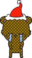 huilende stripboekstijlillustratie van een beer met een kerstmuts vector
