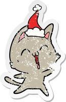 vrolijke, verontruste stickercartoon van een kat met een kerstmuts vector