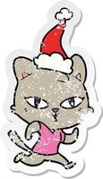 verontruste sticker cartoon van een kat die aan het rennen is met een kerstmuts vector