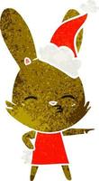 nieuwsgierig konijntje retro cartoon van een dragende kerstmuts vector