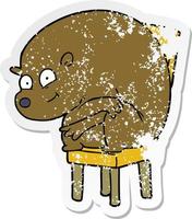 verontruste sticker van een cartoonbeer die op een stoel zit vector