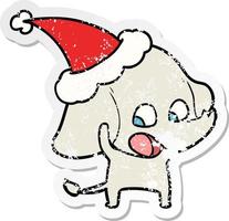 schattige, verontruste stickercartoon van een olifant met een kerstmuts vector