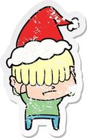 verontruste stickercartoon van een jongen met slordig haar die een kerstmuts draagt vector