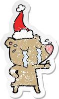 verontruste sticker cartoon van een huilende beer met een kerstmuts vector