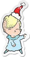 verontruste sticker cartoon van een loensend meisje met een kerstmuts vector