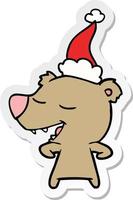 sticker cartoon van een beer met een kerstmuts vector