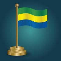 Gabon nationaal vlag Aan gouden pool Aan gradatie geïsoleerd donker achtergrond. tafel vlag, vector illustratie