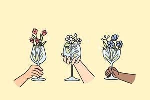 handen van multiraciaal mensen houden wijnglazen met bloemen binnen. creatief bloesem fabriek arrangement in glaswerk voor interieur, feest. bloemen drankje, limonade, cocktail in wijn bril vector concept.