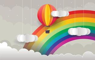 regenboogachtergrond met luchtballon in papercut-stijl vector