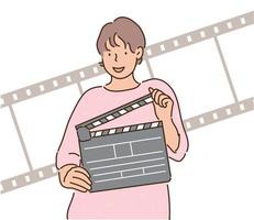 een vrouw houdt een filmklapper vast. handgetekende stijl vectorontwerpillustraties. vector