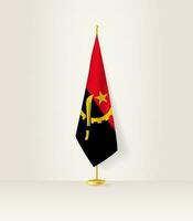 Angola vlag Aan een vlag stellage. vector