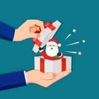 zakenman opent een geschenk doos met de kerstman claus vector