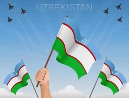 vlaggen van oezbekistan die onder de blauwe lucht vliegen vector