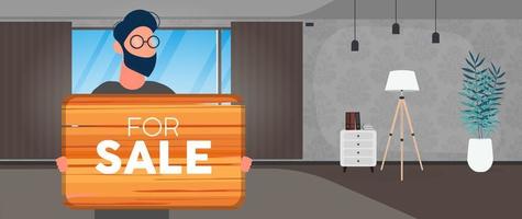een man met een bril houdt een houten bord vast met het opschrift te koop. jonge man met een houten bord. het concept van de verkoop van een appartement, kantoor of gebouw. vector. vector