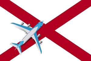 vectorillustratie van een passagiersvliegtuig dat over de vlag van alabama vliegt. concept van toerisme en reizen vector