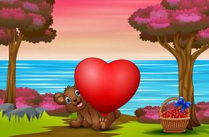 vrolijke baby beer met rood hart ballon in de natuur vector