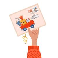 vrouwelijke hand met ansichtkaart met kerststempel en vrolijke momenten belettering tekst met pick-up truck geladen met geschenken. nieuwe felicitatiekaart voor het jaar 2022 vector