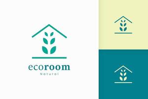 natuur groen huis logo met boom en bladvorm vector