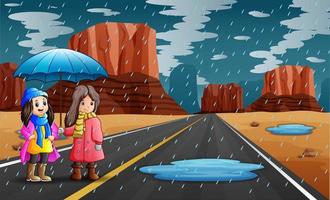 twee meisjes die paraplu in de regen houden vector