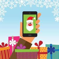 Hand met een mobiele telefoon met geschenken en de kerstman op het apparaat vector