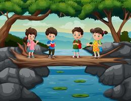 schattige kinderen steken de rivier over op de boomstambrug vector