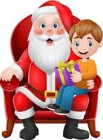 de kerstman zit in een stoel met een kleine schattige jongen