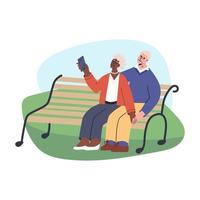 gelukkige senior paar nemen selfie zittend op een bankje in het park. oudere man en vrouw leiden een actieve levensstijl.