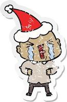 verontruste sticker cartoon van een huilende kale man met een kerstmuts vector