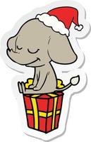 sticker cartoon van een lachende olifant met een kerstmuts vector