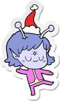 sticker cartoon van een buitenaards meisje met een kerstmuts vector