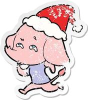 verontruste sticker cartoon van een olifant die herinnert zich het dragen van een kerstmuts vector