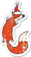 verontruste sticker cartoon van een springende vos met een kerstmuts vector