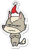 stickercartoon van een geërgerde wolf die een kerstmuts draagt vector