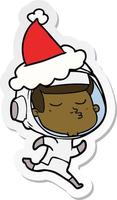 stickercartoon van een zelfverzekerde astronaut met een kerstmuts vector