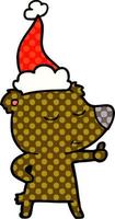 vrolijke stripboekstijlillustratie van een beer die duimen opgeeft met een kerstmuts vector