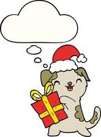 schattige cartoon puppy met kerstcadeau en hoed en gedachte bel vector