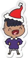 sticker cartoon van een gelukkige jongen die lacht met een kerstmuts vector