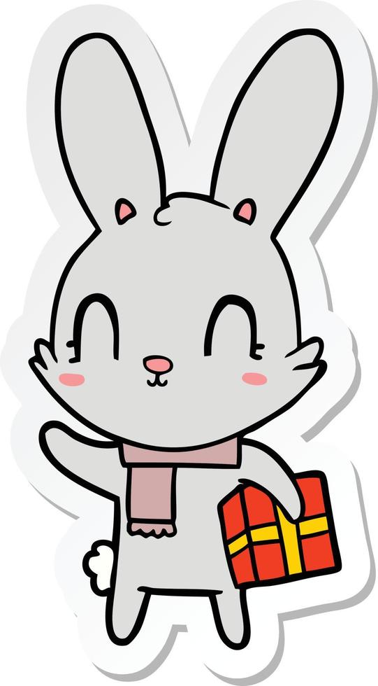 klistermärke av en söt tecknad kanin med julklapp vektor